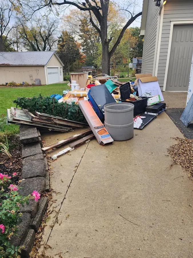 Dumpster being loaded with debris for Estate Cleanout Dumpster Rental in Madison